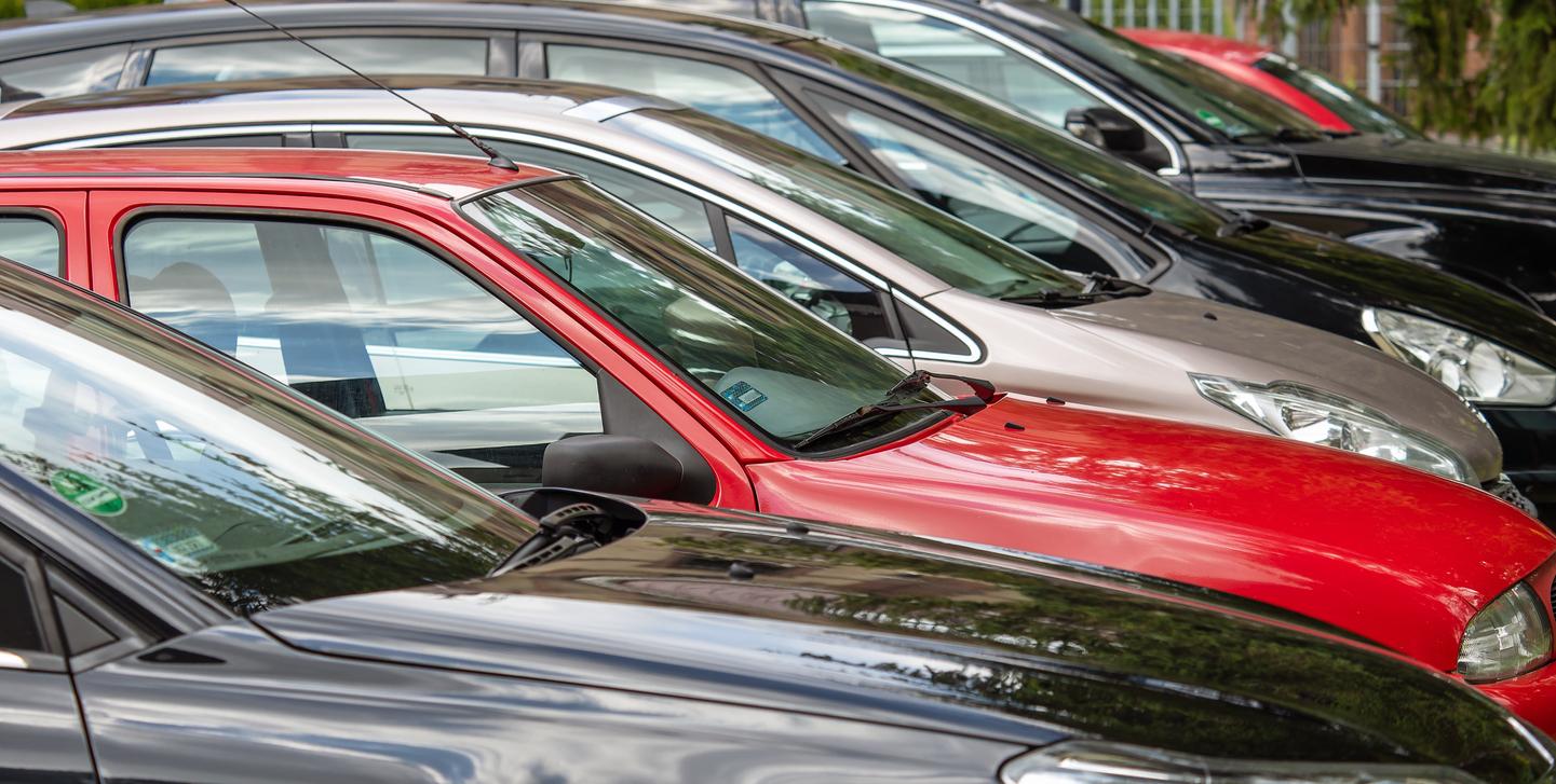 Various cars sitting on a lot.